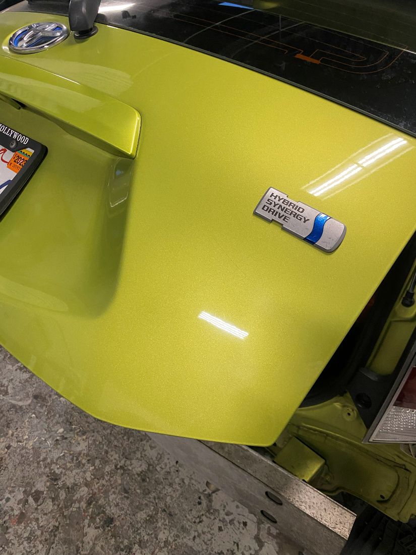 The same yellow tailgate after paintless dent repair
