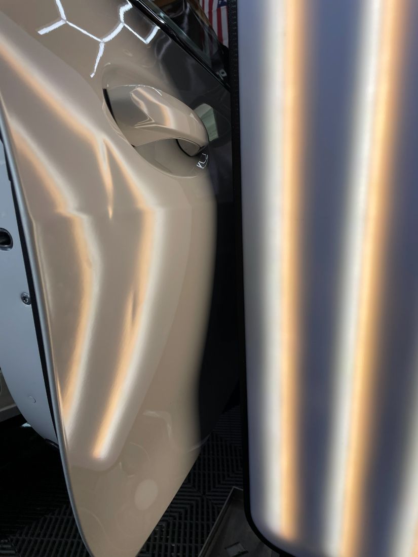 Crease on a white door before repair